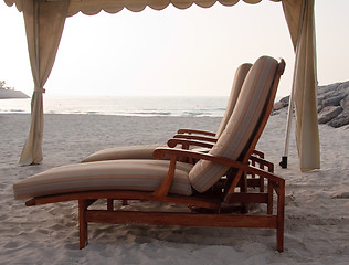 Image showing Pair of sun loungers on beach