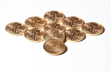 Image showing Diamond shaped gold coins on white