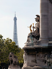 Image showing Eiffel tower framed by statue on Pont Alexandre Bridge