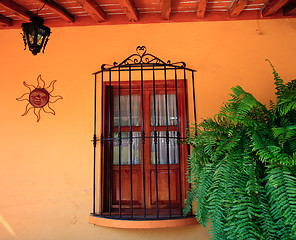 Image showing Orange wall with wooden window