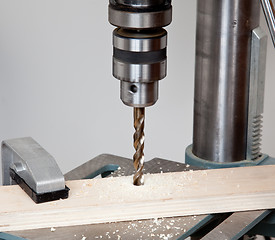 Image showing Close up of drill bit above wood