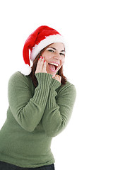 Image showing surprised christmas woman wearing a santa hat smiling isolated o