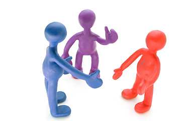 Image showing Colored plasticine puppets talking on white background