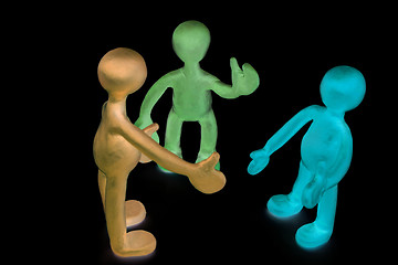 Image showing Shaded plasticine puppets talking on black background