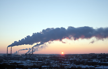 Image showing winter industrial sunset with smoke