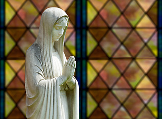 Image showing Isolated statue of Mary against window