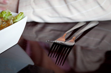 Image showing Pair of forks reflecting from dinner table