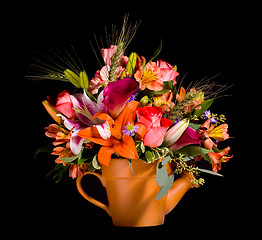 Image showing Bouquet of flowers in watering can