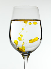 Image showing Olive oil being poured into wine glass