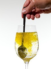 Image showing Olive oil being stirred in wine glass