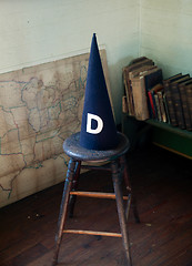 Image showing Old dunce cap on stool
