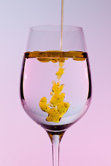 Image showing Olive oil being poured into wine glass