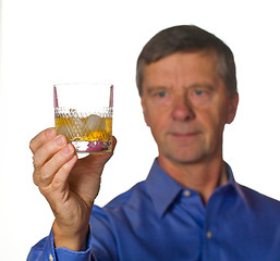Image showing Senior man with glass of whisky