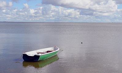 Image showing Lonely plastic boat tied near quiet lake shore.