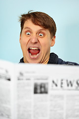 Image showing Man shocked - bad news from newspaper