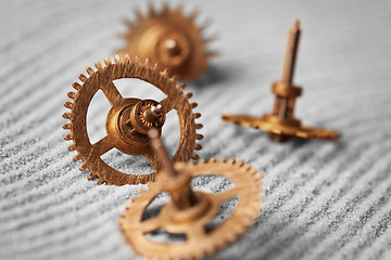 Image showing Watch gears on sand - abstract still life