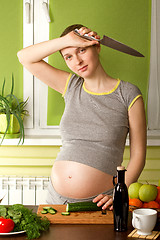Image showing pregnant woman on kitchen with knife