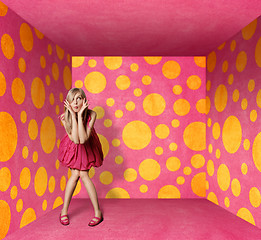 Image showing surprised blonde in pink dress in pink room