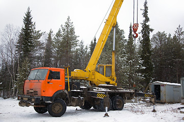 Image showing crane working in the woods in winter