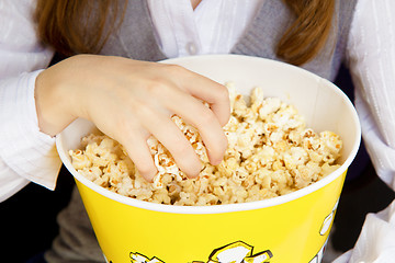 Image showing hand in a bucket of popcorn