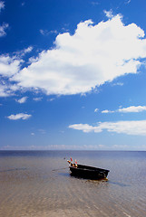 Image showing Plastic boat with floats tied at seaside.