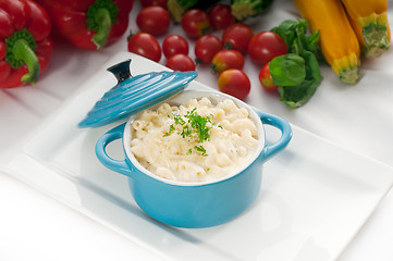 Image showing mac and cheese on a blue little clay pot