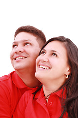 Image showing Young loving couple looking up to the sky, standing over white, 