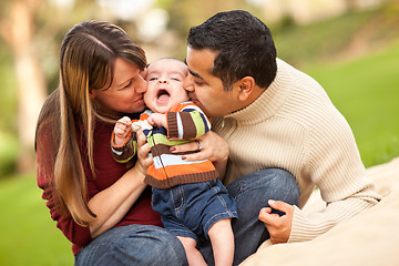 Image showing Happy Mixed Race Parents Playing with Their Son