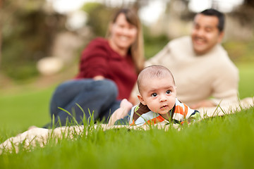 Image showing Happy Baby Boy and Mixed Race Parents Playing in the Park