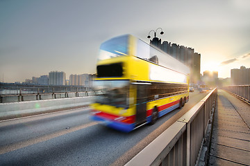 Image showing speed bus through sunset road