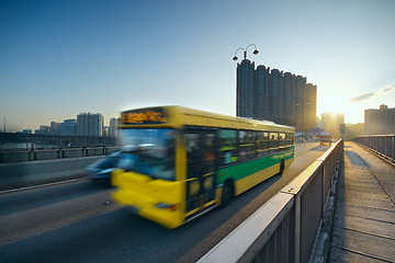 Image showing speed bus through sunset road