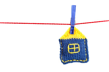 Image showing knitted house on a red string