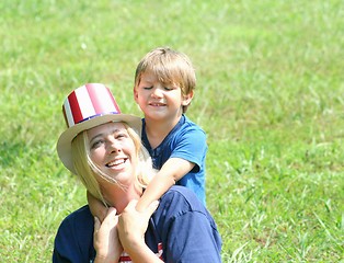 Image showing  Young mother and baby in 4th of july hats