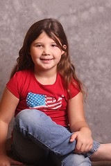 Image showing young girl in jeans and red shirt