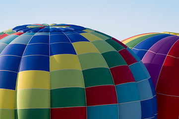 Image showing Top sections of hot-air balloons inflating or ascending