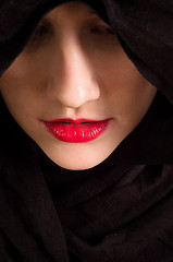 Image showing Girl looking down with black hood