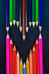 Image showing Colorful pencils on dark background in a shape of a heart