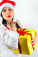 Image showing Girl giving a big kiss and a present