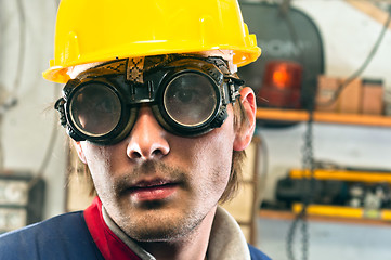 Image showing Closeup of an industrial worker in yellow helmet