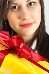 Image showing Christmas present with a beautiful girl in the background