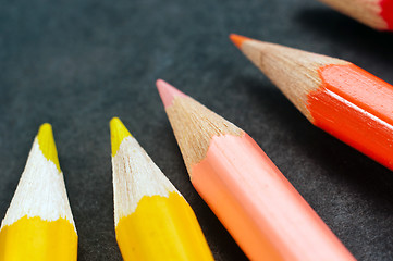 Image showing Colorful pencils on dark background lined up