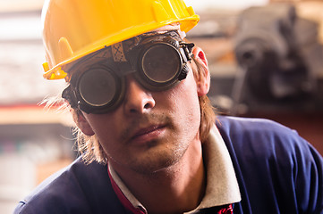Image showing Closeup of an industrial worker in yellow helmet