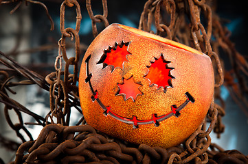 Image showing Halloween pumkin cought in the web of chains