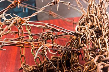 Image showing Barbed wire and chain of sorrow linked in each other