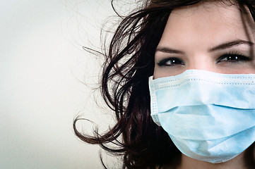 Image showing A girl in a protective mask against white isolated background