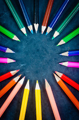 Image showing Colorful pencils on dark background in a circle