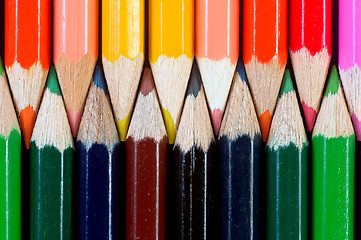 Image showing Colorful pencils on dark background lined up