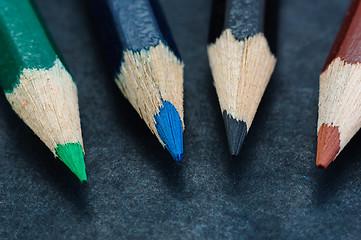 Image showing Colorful pencils on dark background lined up