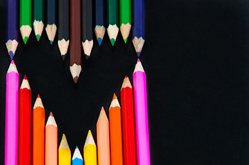 Image showing Colored pencils in heart shape on white