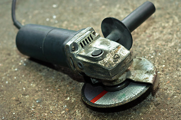 Image showing A used circular saw on concrete floor